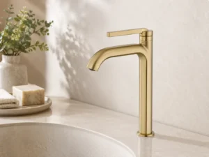 Brass basin faucet on a bathroom vanity used to explain unlacquered brass living finish behavior